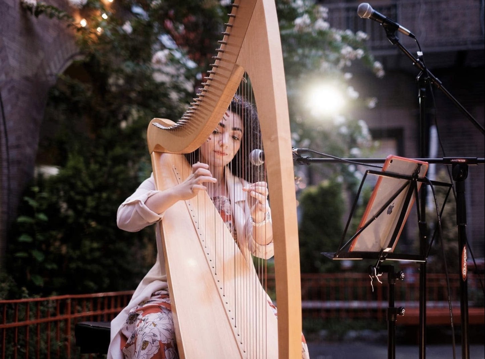 Christa Dalmazio playing harp and singing at Catholic NYC's Love and Responsibility event